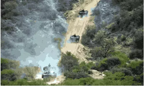 Army tanks roll down during a military exercises in Tilla Field Firing Range