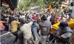BJP members and security personnel clash during a protest organised to mark the completion of one year of the rape and murder of a trainee doctor at RG Kar hospital, in Kolkata