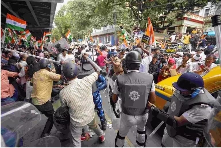 BJP members and security personnel clash during a protest organised to mark the completion of one year of the rape and murder of a trainee doctor at RG Kar hospital, in Kolkata